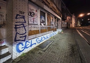 Decaying façade smeared with graffiti, scrap property in Gelsenkirchen, one of the poorest cities