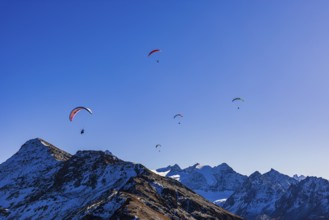 Paragliders fly over the mountains of the Valais Alps, Val d'Anniviers, Valais Alps, Canton of