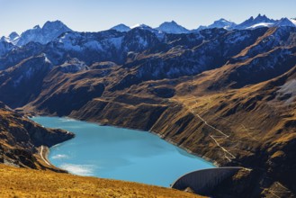 The turquoise Lac de Moiry reservoir with the dam, behind the peaks of the Grand Cornier, Tete