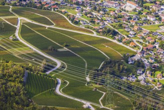 Power lines across vineyards and fields, in the back the village of Chalais, view of Vercorin, Val