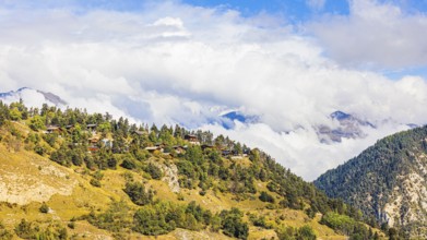 Rising fog over the mountain village of Vercorin, Val d'Anniviers, Valais Alps, Canton of Valais,