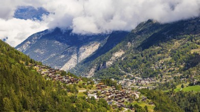 Rising fog in the Val d'Anniviers, below the mountain village of Saint-Jean, Valais Alps, Canton of