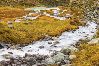 A glacier stream flows from Lac de Chateaupre into the Lac de Moiry reservoir, Val d'Anniviers,