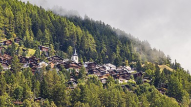 Rising fog over the mountain village of Saint-Luc, Val d'Anniviers, Valais Alps, Canton of Valais,