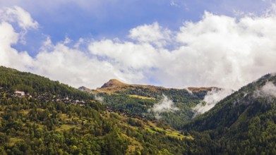 Fog rises in Val d'Anniviers, behind the Pointes de Nava hill, Valais Alps, Canton of Valais,