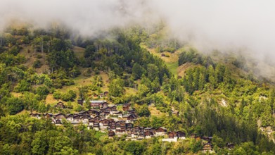 Fog over the mountain village of Pinsec, Val d'Anniviers, Valais Alps, Canton of Valais,