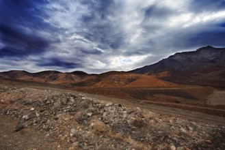 Dramatic mountain landscape with cloudy sky and rugged terrain, Pajara Fuerteventura, Canary Island