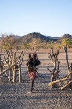 Himba woman with child, traditional Himba village, Kaokoveld, Kunene, Namibia