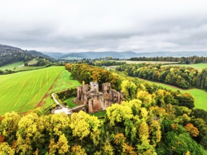 Autumn Colours over ruins of Goodrich Castle and River Wye from a drone, Goodrich, Herefordshire,