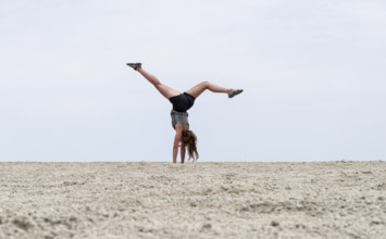 Abstract, woman doing gymnastics in a whirring landscape, Etosha pan, Etosha National Park, Namibia