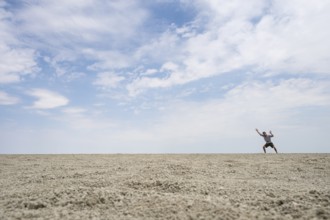 Symbolic picture, abstract, man at the Etosha pan, salt pan, Etosha National Park, Namibia