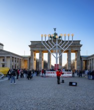 Large Hanukkah chandelier at the Brandenburg Gate in daylight, sign of lively Jewish life, symbolic