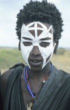 Portrait of a Maasai boy with face painted white on the occasion of his initiation, Ngorongoro