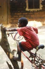 Little boy on a bicycle, Zanzibar, Tanzania, Africa, June 2000, vintage, retro, old, historic