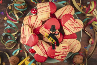 Heart-shaped cookies with red icing and decoration for New Year