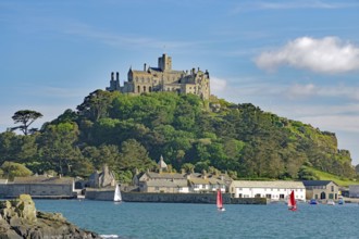 A majestic castle perched on a green hill in front of the sea, Penzance, Saint Michael's Mount,