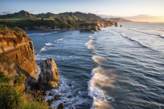 The Three Sisters and Elephant Rock formations, sea, evening, golden hour, sunset. Taranaki Region,