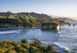 The Three Sisters and Elephant Rock formations, sea, evening, golden hour. Taranaki Region, North