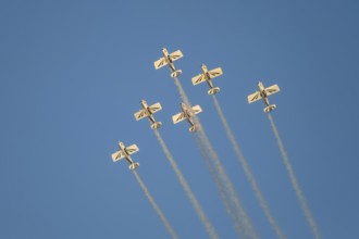 Stunt aerobatic planes performing stunts in blue sky with smoke trail. Concept of teamwork,