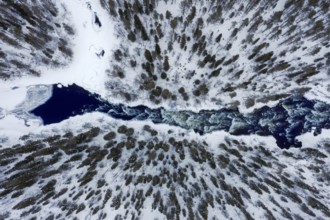 Aerial view over rapids in the river Kitkajoki in winter, Oulanka National Park, Northern