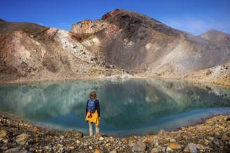 A hiker at one of the Emerald Lakes and Red Crater, Panorama, Tongariro alpine crossing, Tongariro