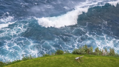 Deckchair in a meadow off coast with waves in the sea, beautiful view, Madeira, Portugal