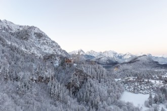 Neuschwanstein Castle is surrounded by snowy mountain scenery, Schwangau near Füssen, Ostallgäu,