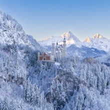 The enchanting Neuschwanstein Castle in a symmetrical, snowy mountain landscape, Schwangau near