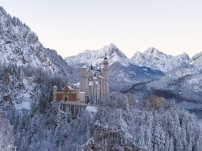 Neuschwanstein Castle rises majestically in a snowy alpine landscape, Schwangau near Füssen,
