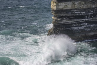 Waves blaze against the Dun Briste Sea Stack at Downpatrick Head, Lackan, County Mayo, Ireland