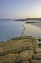 Granite rocks in the evening light and turquoise blue sea at Gurteen Beach, Roundstone, County