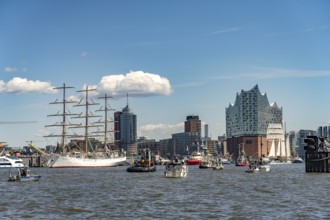 Incoming parade of ships and sailboats at Hafengeburtstag Hamburg 2025 in front of the Elbe