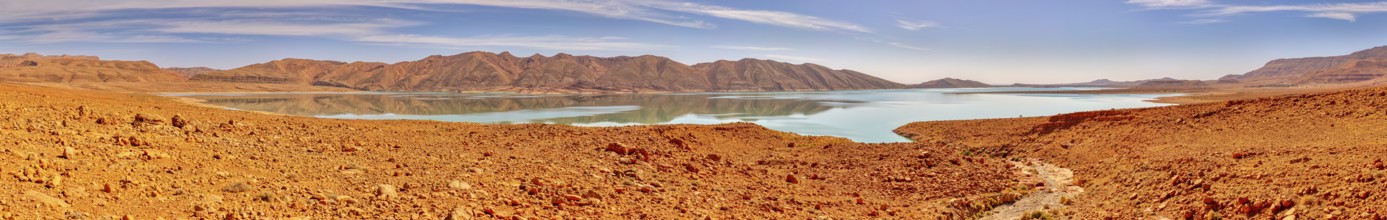 Wide desert landscape with a lake and mountains under clear sky, reservoir, Al-Hassan Addakhil