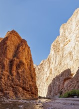 Deep rock gorge with a narrow stream and impressive stone structure, Todra Gorge in Morocco
