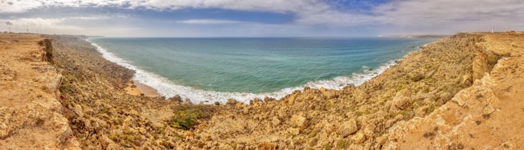 Panoramic view of rocky coast with blue sea