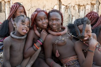 Group of Himba people, Himba woman, traditional Himba village, Kaokoveld, Kunene, Namibia