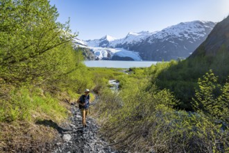 Hikers on the Portage Pass Trail, snowy mountains, Portage Glacier and Portage Lake, near Whittier,