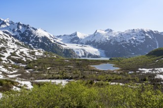 View from Portage Pass of Divide Lake, snowy mountain peaks and glaciers Portage Glacier, Portage