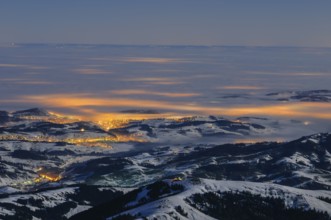 Night shot, long exposure of the 2506 meter high Säntis into the wintery, snow-covered, fog-covered