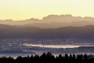 View from Horben of Lake Zug with the town of Cham and Zug, behind it the snow-capped mountains
