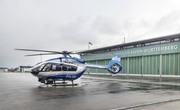 Helicopter from the Baden-Württemberg Police team in front of the hangar at the airport. Airbus