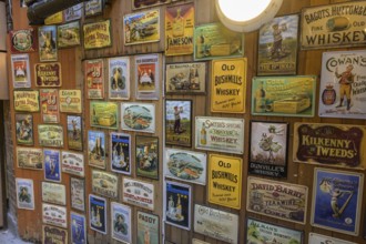 Wall with tin billboards in a whiskey shop, Dublin, County Dublin, Ireland