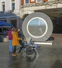People on the Cornhill in the town centre view the first ever UK Portal in Ipswich, Suffolk,
