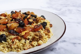 Rice dish, with the addition of dried fruits, nuts and spices of Middle Eastern cuisine, homemade,