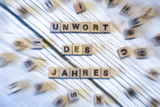 Letter cubes spell out the words UNWORD OF THE YEAR