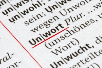 Symbol image of the Word of the Year: Close-up of the term UNWORT (bad word) in the Duden