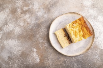 ?ottage cheese ?asserole, Curd cake, with dried apricots and raisins on brown concrete background,