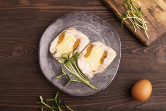 Chicken, egg and dried apricot meatloaf, microgreen on brown wooden. Diet, healthy eating. top