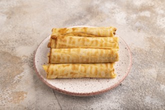 Waffles with caramel on brown concrete background, side view, close up