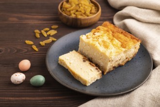 ?ottage cheese ?asserole, Curd cake, with dried apricots and raisins on brown wooden background and